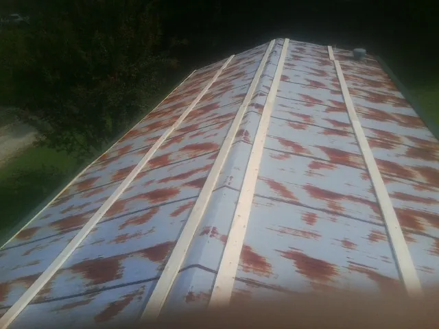 Rusted metal roof panels with new wood purlins before replacement — Storm Damage Roof Repair in Lake Lure by Roofing Brothers